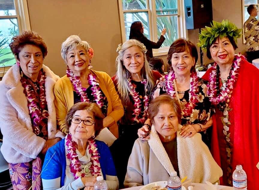 Women wearing lei garlands Hawaiian celebration event