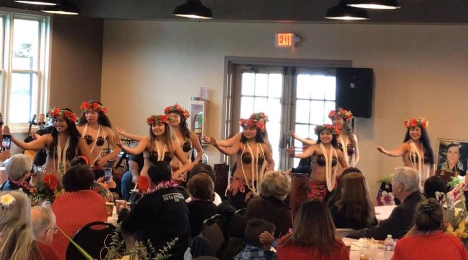 Luau show performers on stage with audience