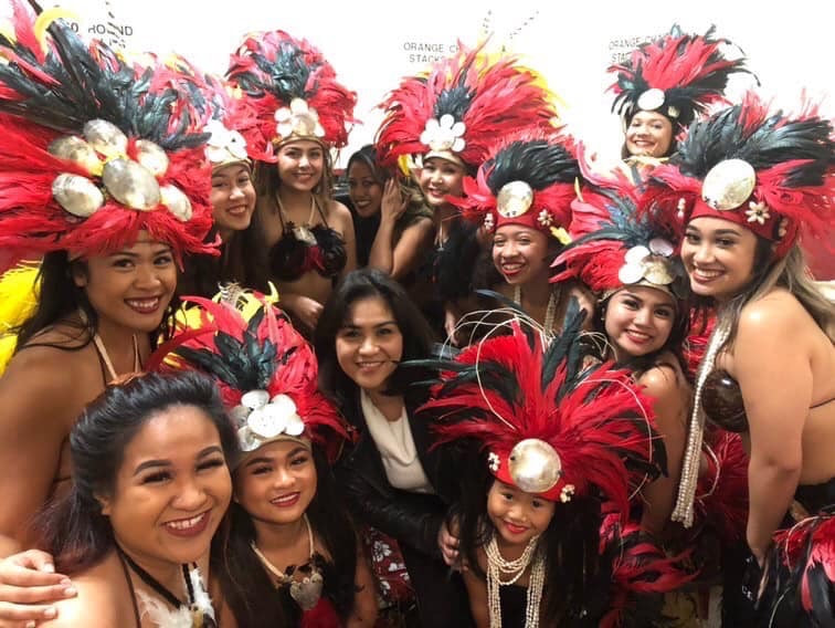Group photo carnival costumes feathered headdresses luau